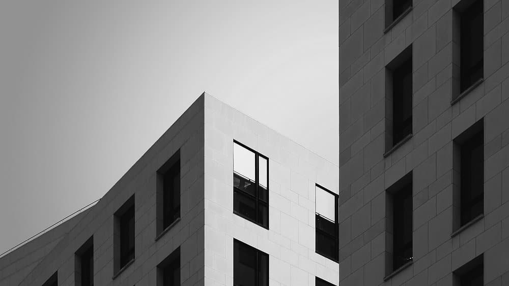 Fachada moderna en blanco y negro con ventanas geométricas